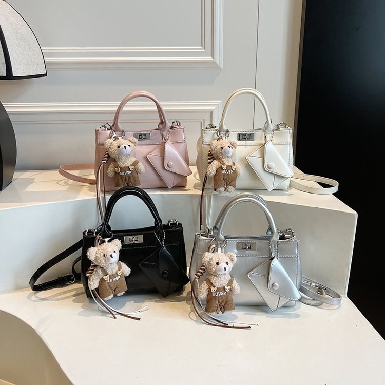 Mini handbag with sloping side panels and twin handles · BG-028